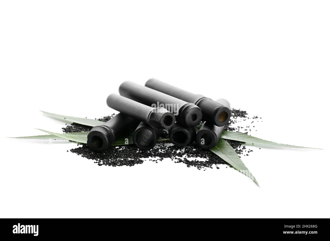 Black bamboo sticks and activated carbon powder isolated on white