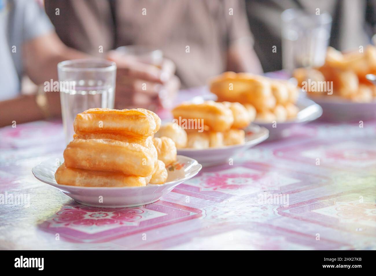 Chinese donut or Chinese breadstick at an ancient coffee shop. Traditional food in Laos and Southeast Asia. Close-up. Stock Photo