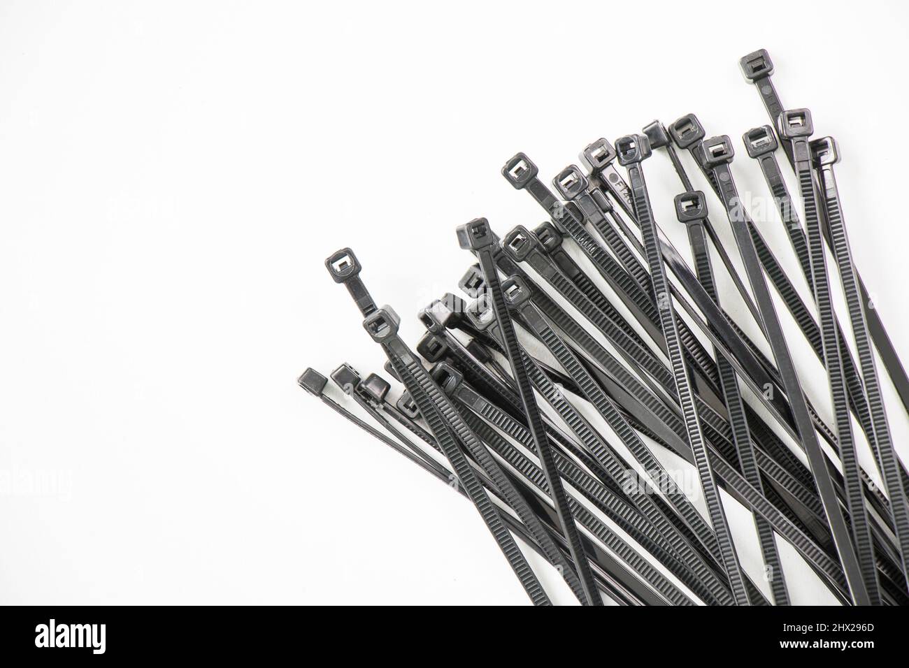 Black cable tie on the white background, high angle view Stock Photo