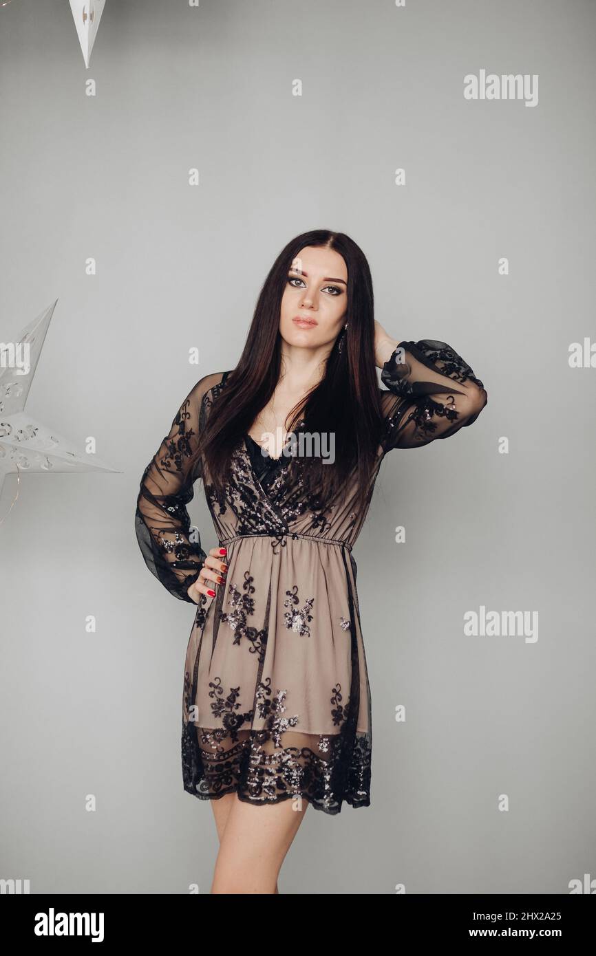 Gorgeous brunette model in black dress and heels Stock Photo - Alamy