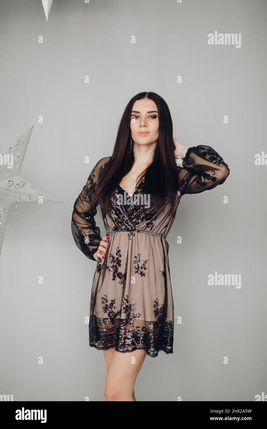 Gorgeous brunette model in black dress and heels Stock Photo - Alamy