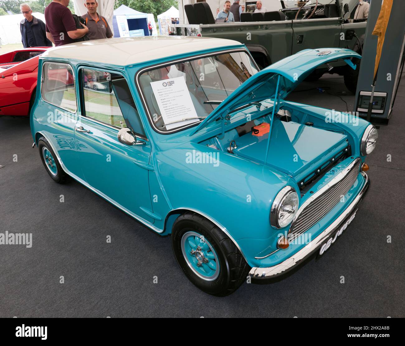 Three-quarters front view of a 1967 Austin Mini, fitted with a Tesla Drive Unit, by electric classic cars, on display at the London Classic Car Show Stock Photo