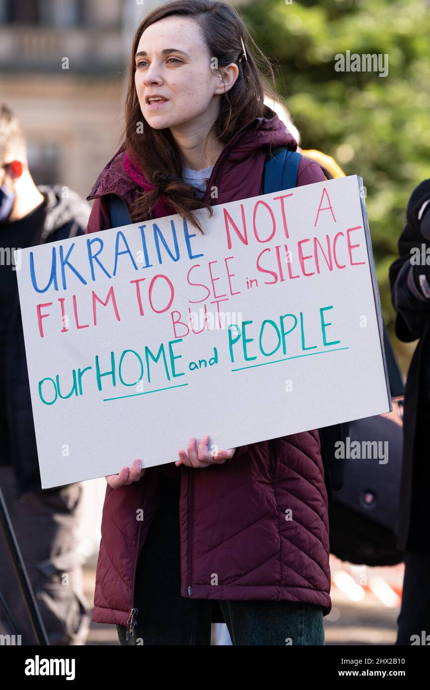Ukraine war protester in uk - 'Ukraine not a film to see in silence but our home and people' sign at Ukraine rally protest in Glasgow, Scotland, UK Stock Photo