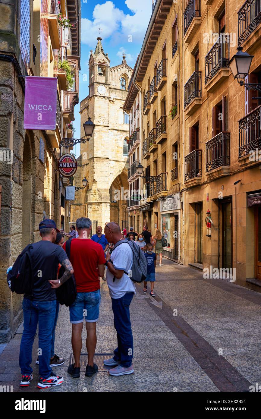 Tourists walking through the Old Town, in the background Church of San Vicente, Donostia, San Sebastián, Gipuzkoa, Basque Country, Spain, Europe, Stock Photo