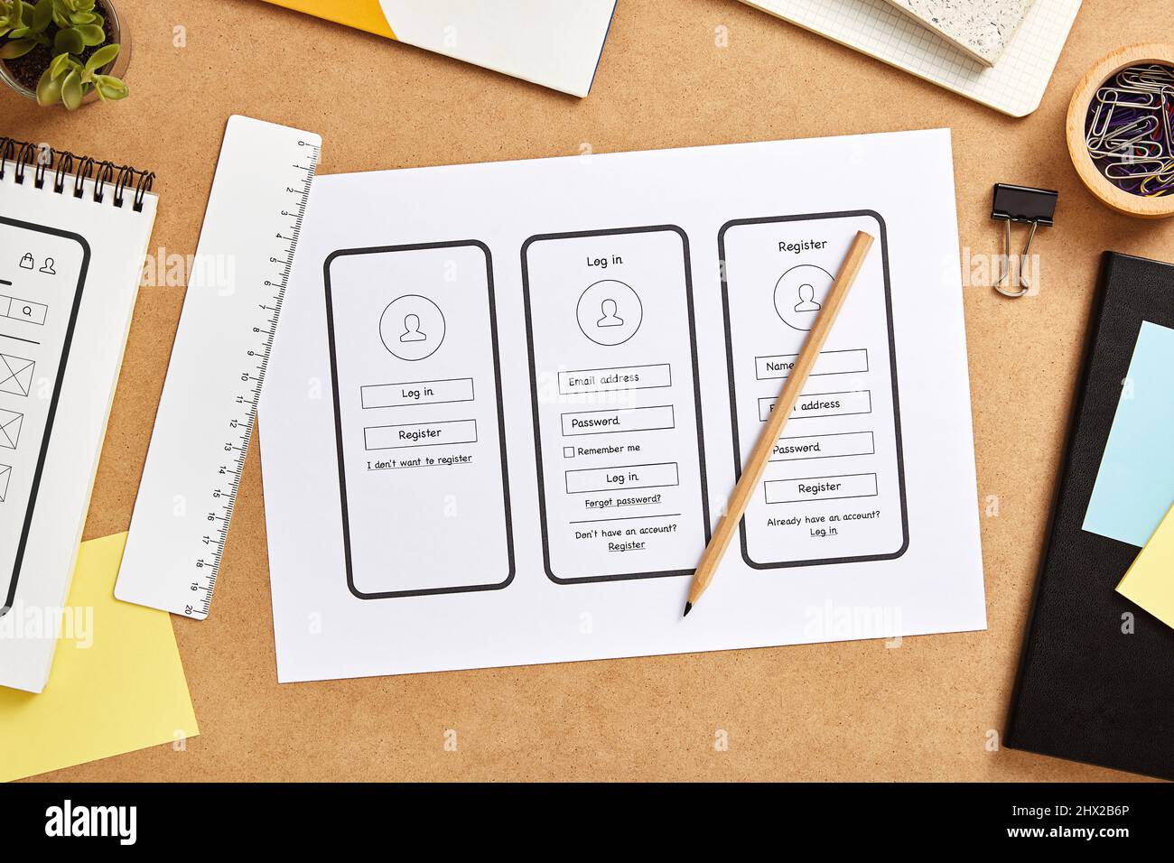 UX design concept. Mobile app wireframe sketches over product designer desk. Top view. Stock Photo