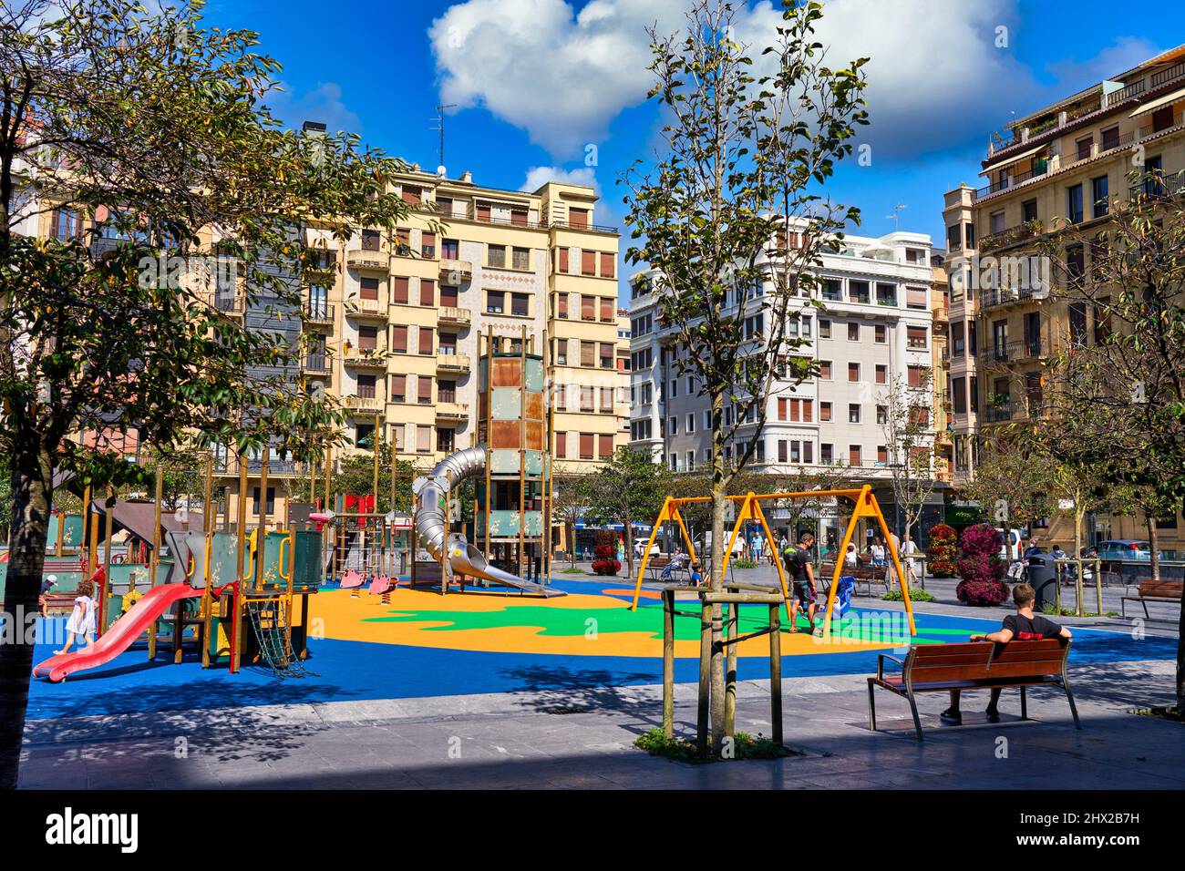 Children playing in a playground, Plaza Cataluña, Barrio de Gros, one of the most atmospheric neighborhoods in the city, Donostia, San Sebastián, Stock Photo