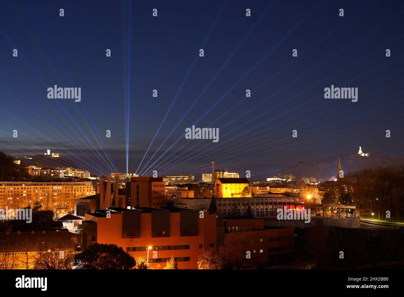 Laser lighting from Santa Clara Island, Mount Igeldo to the left and Mount Urgull to the right, San Sebastian, a cosmopolitan city of 187,000 Stock Photo