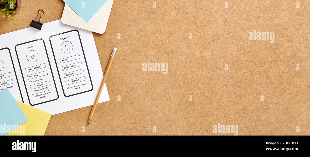 User experience design concept web banner with copy space. Top view image of a product designer workspace with mobile app wireframe sketches. Stock Photo