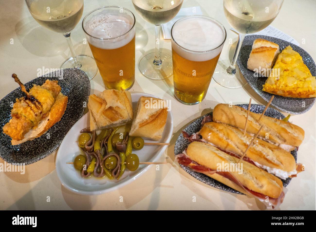 Spain, Basque country, Guipuzcoa, Food, Pintxos with Txacoi wine and beer, at Zarrauz. Stock Photo