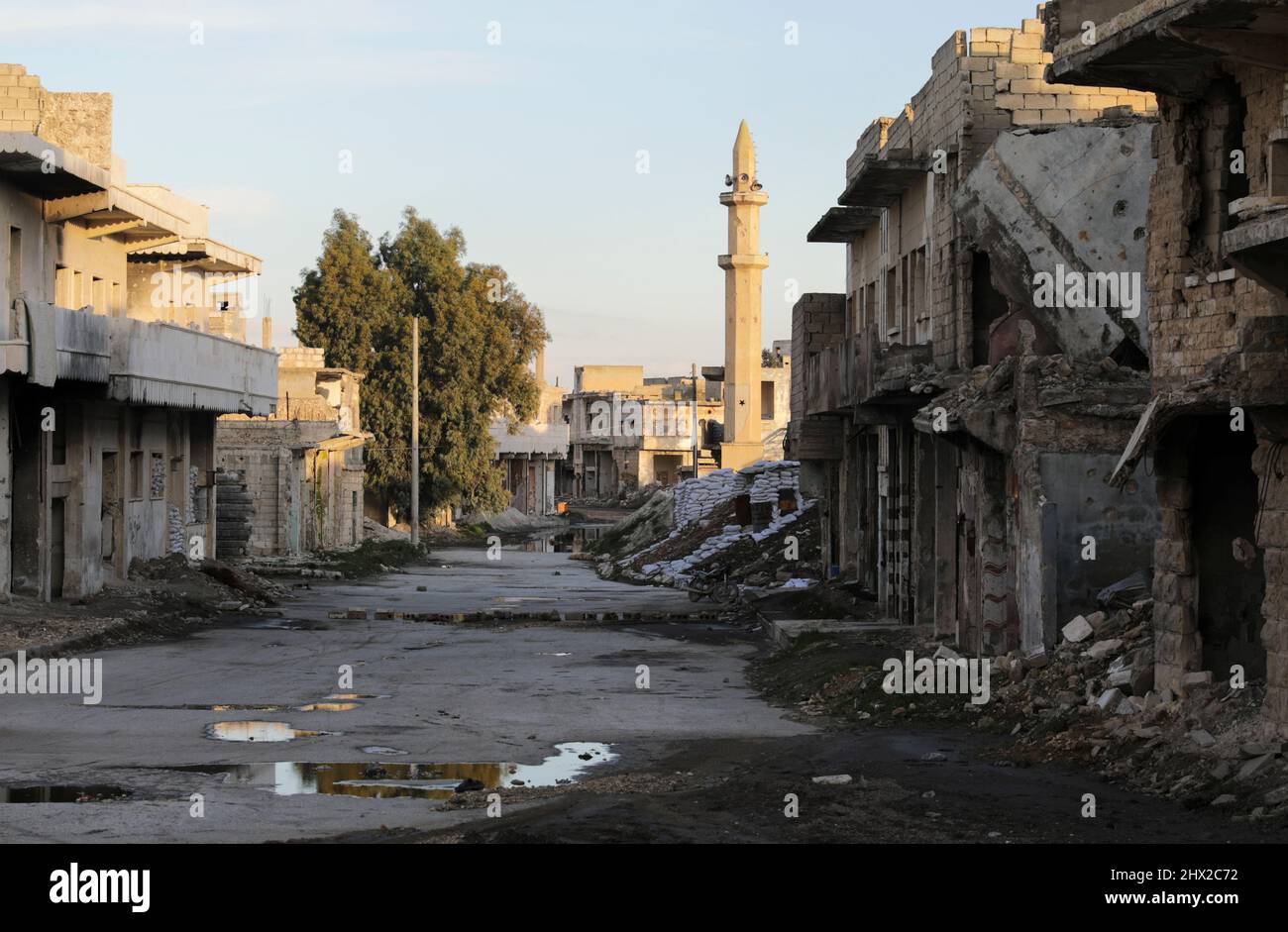 Damaged buildings are pictured along a deserted street in the rebel-held town of Tadef, on a frontline between Russian-backed Syrian government forces and Turkey-backed Syrian rebel-held territory, in northern Syria March 4, 2022. Picture taken March 4, 2022.  REUTERS/Khalil Ashawi Stock Photo