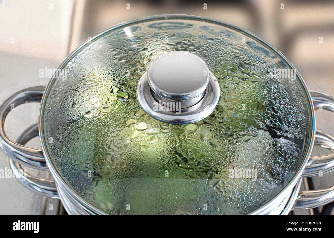 Pot lid steaming vegetables Stock Photo Alamy