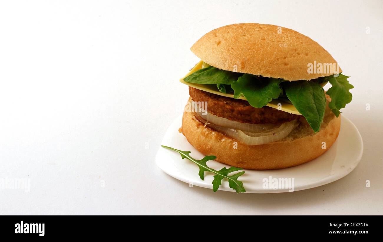 Vegan burger. Meat based on soy and wheat proteins. Cheese based on coconut oil. Stock Photo