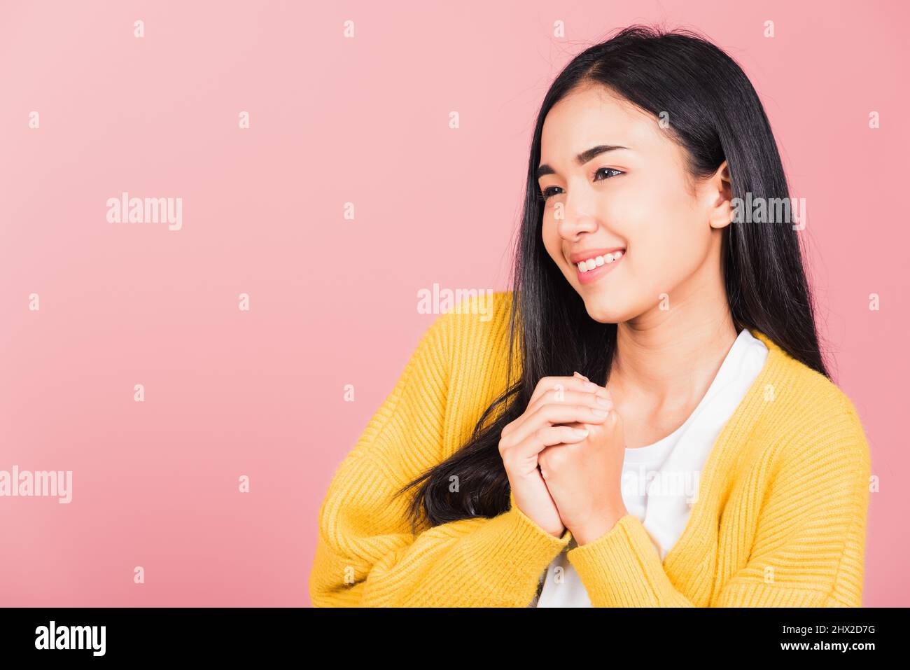 Happy Asian portrait beautiful cute young woman teen stand excited expression fist pressed together under chin pleased and delighted, thanking help st Stock Photo