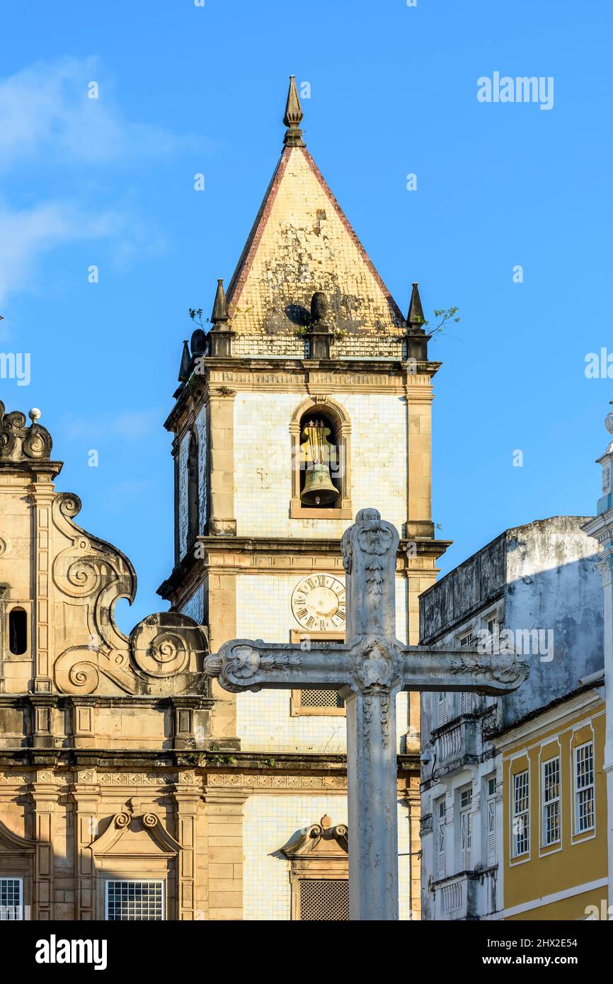Facade facade of an old historic church with a large crucifix in the central square in Pelourinho, histoic center of Salvador city, Bahia. Stock Photo