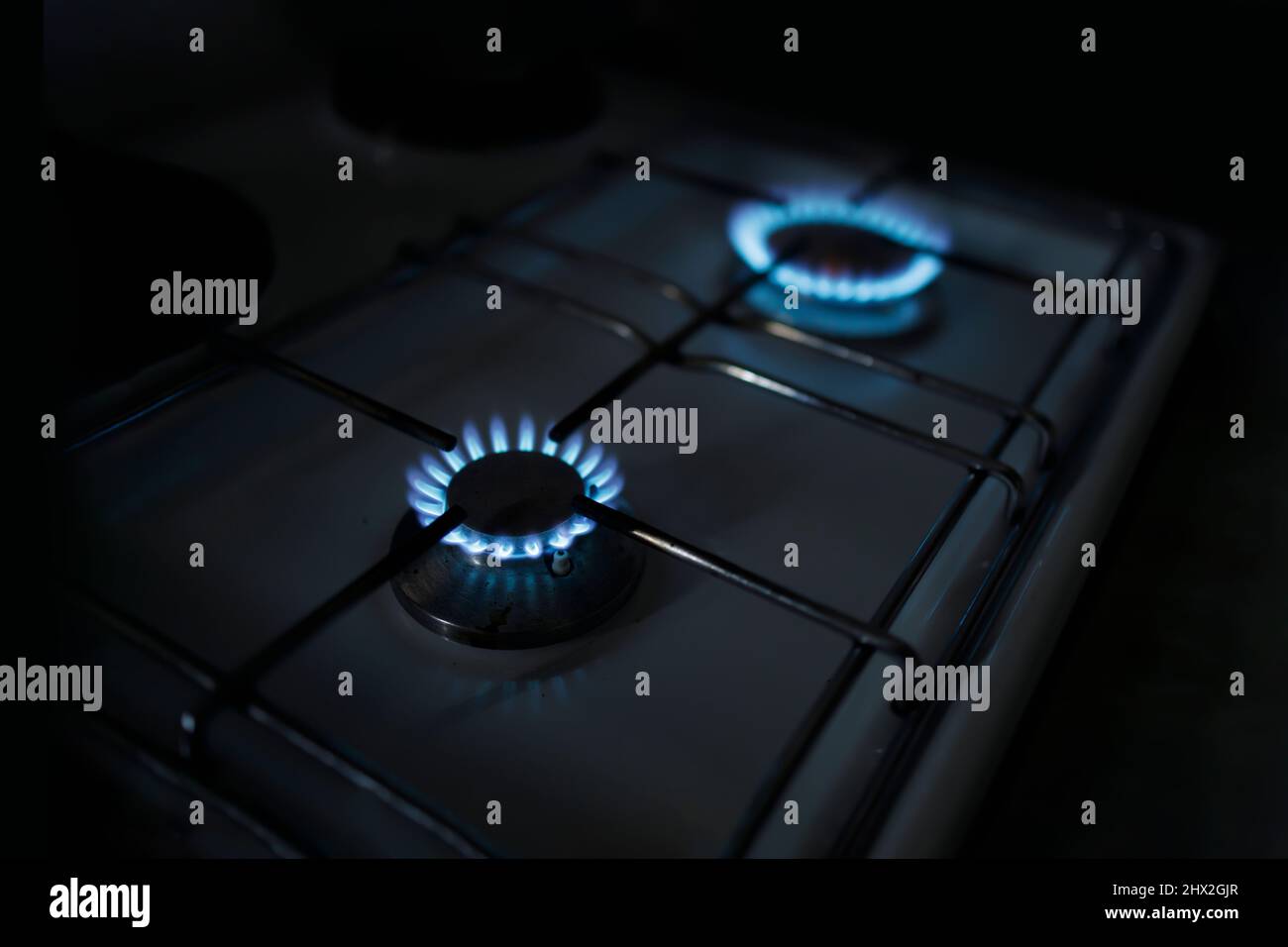 Two gas burners alight while the power is out due to restrictions Stock
