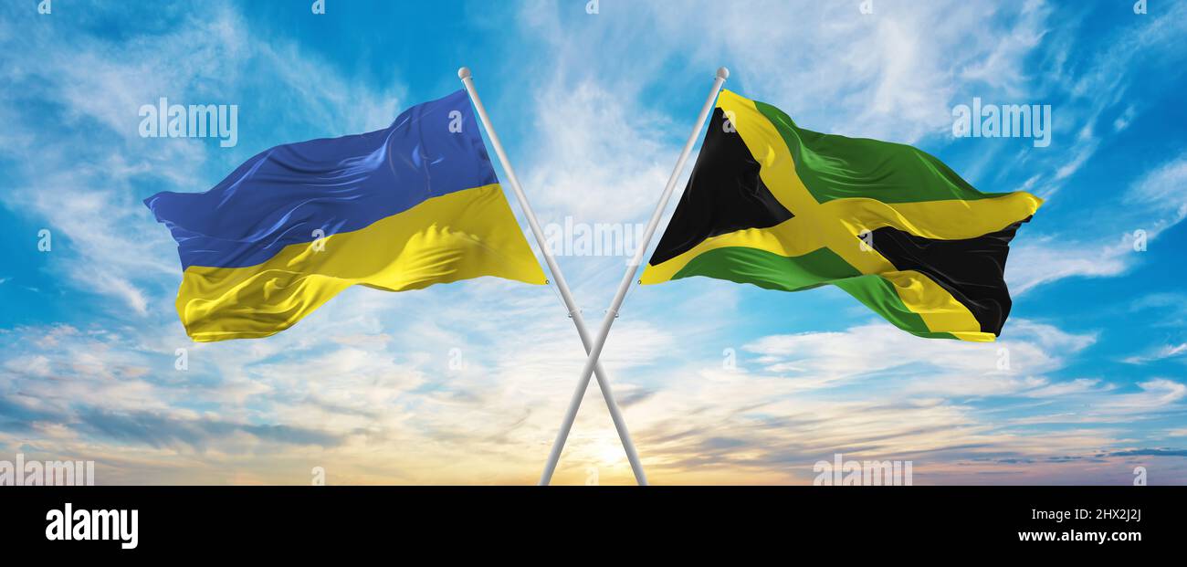crossed national flags of Ukraine and Jamaica flag waving in wind at ...