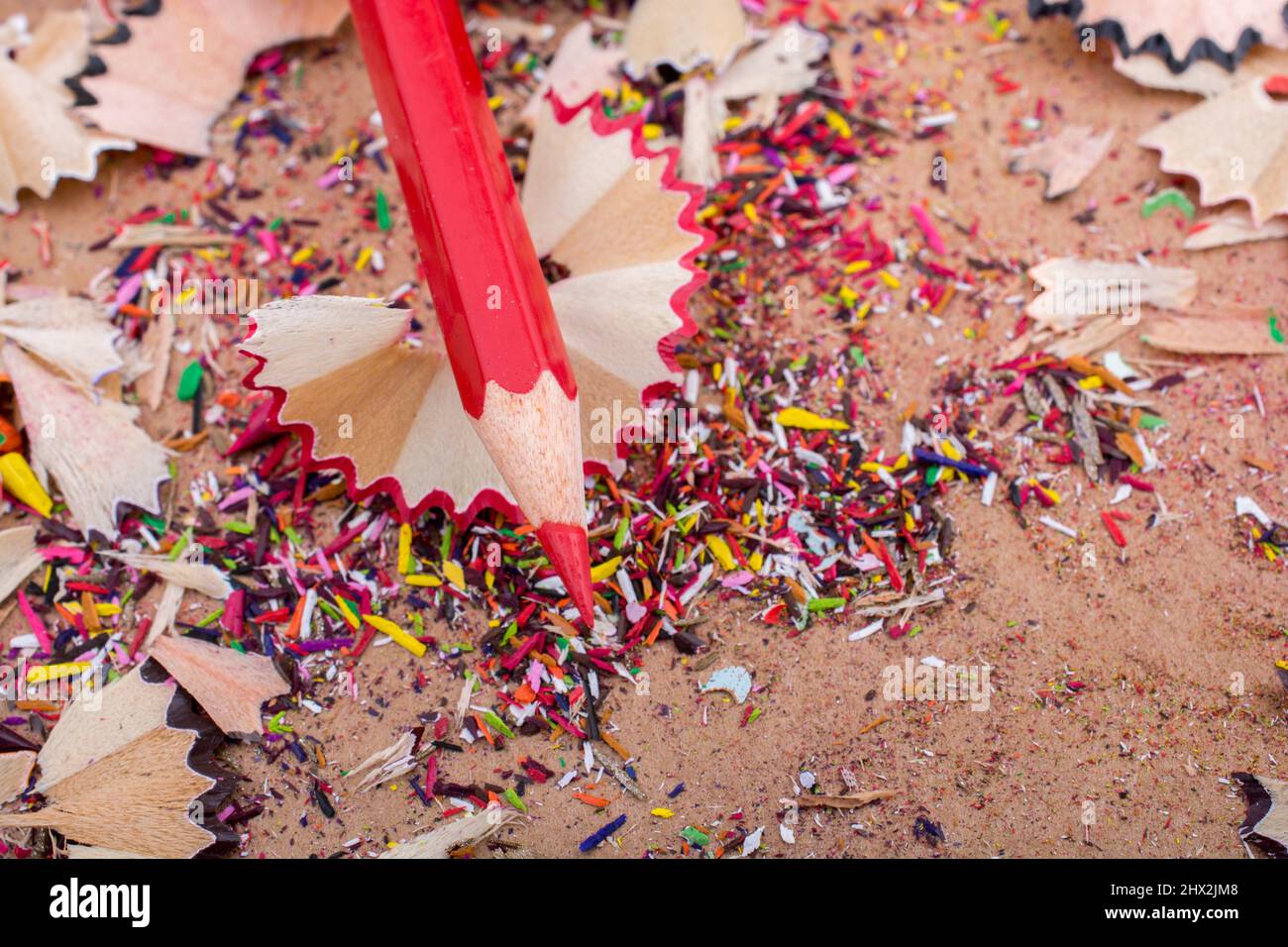 Red Color Pencil over some pencil shavings. Stock Photo