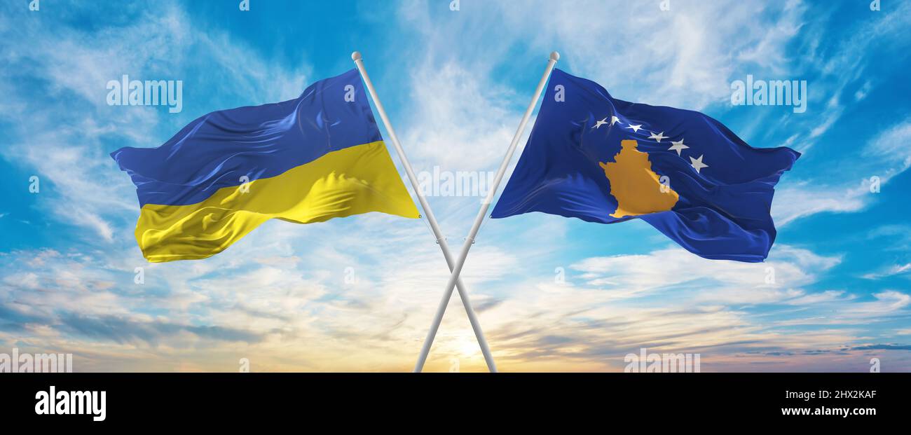 crossed national flags of Ukraine and Kosovo flag waving in wind at ...