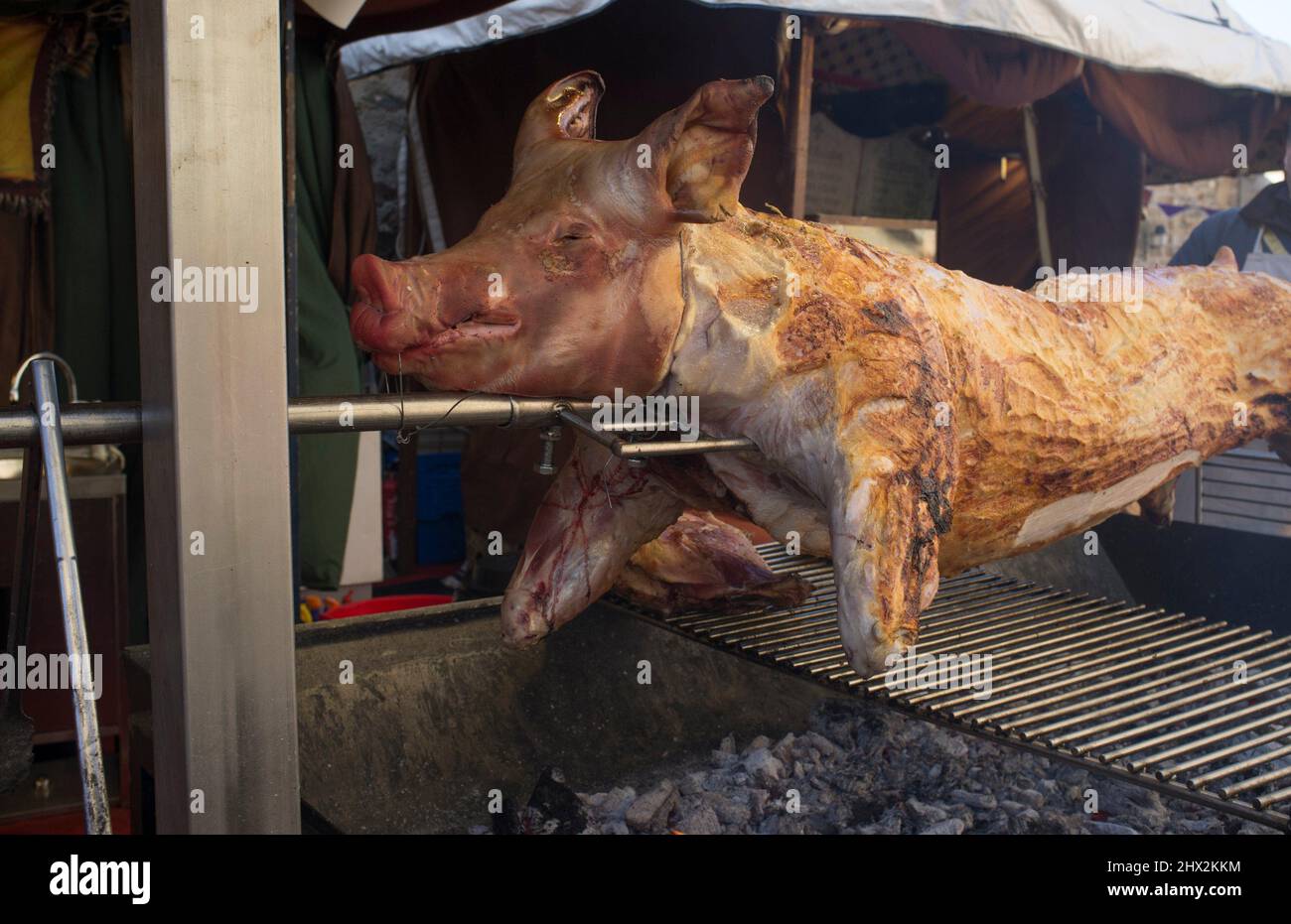 Whole pig being roasted as medieval times. Selective focus. Stock Photo