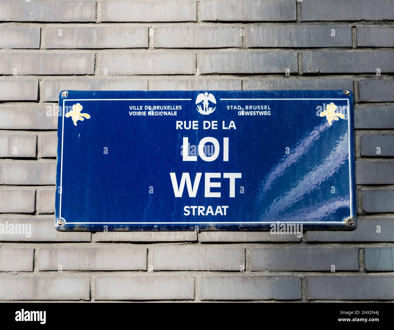 City of Brussels - Belgium -Streetname tag on a brick facade of the Rue de la Loi - Wetstraat- Law street in the European and business quarter. Stock Photo