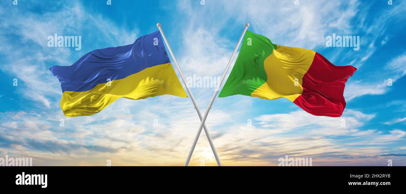 crossed national flags of Ukraine and Mali flag waving in wind at ...
