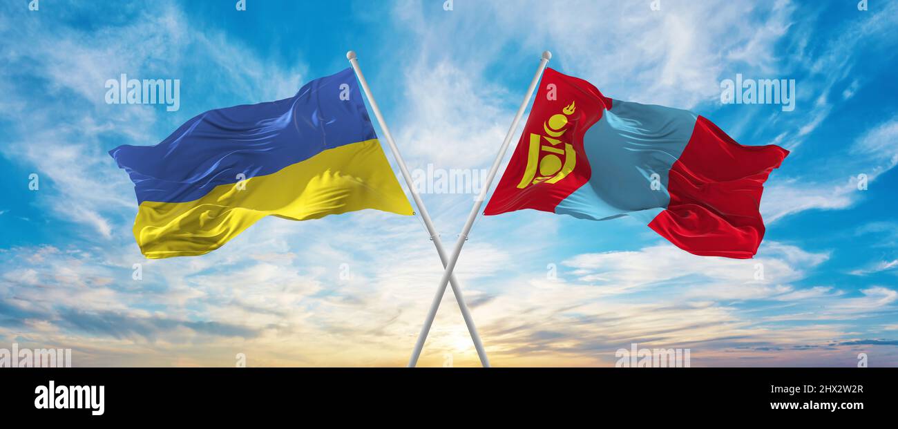 crossed national flags of Ukraine and Mongolia flag waving in wind at ...