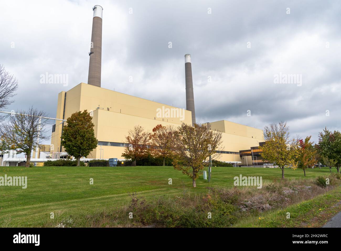 View of a gas-fired power plant with two tall chimneys under cloudy sky in autumn Stock Photo