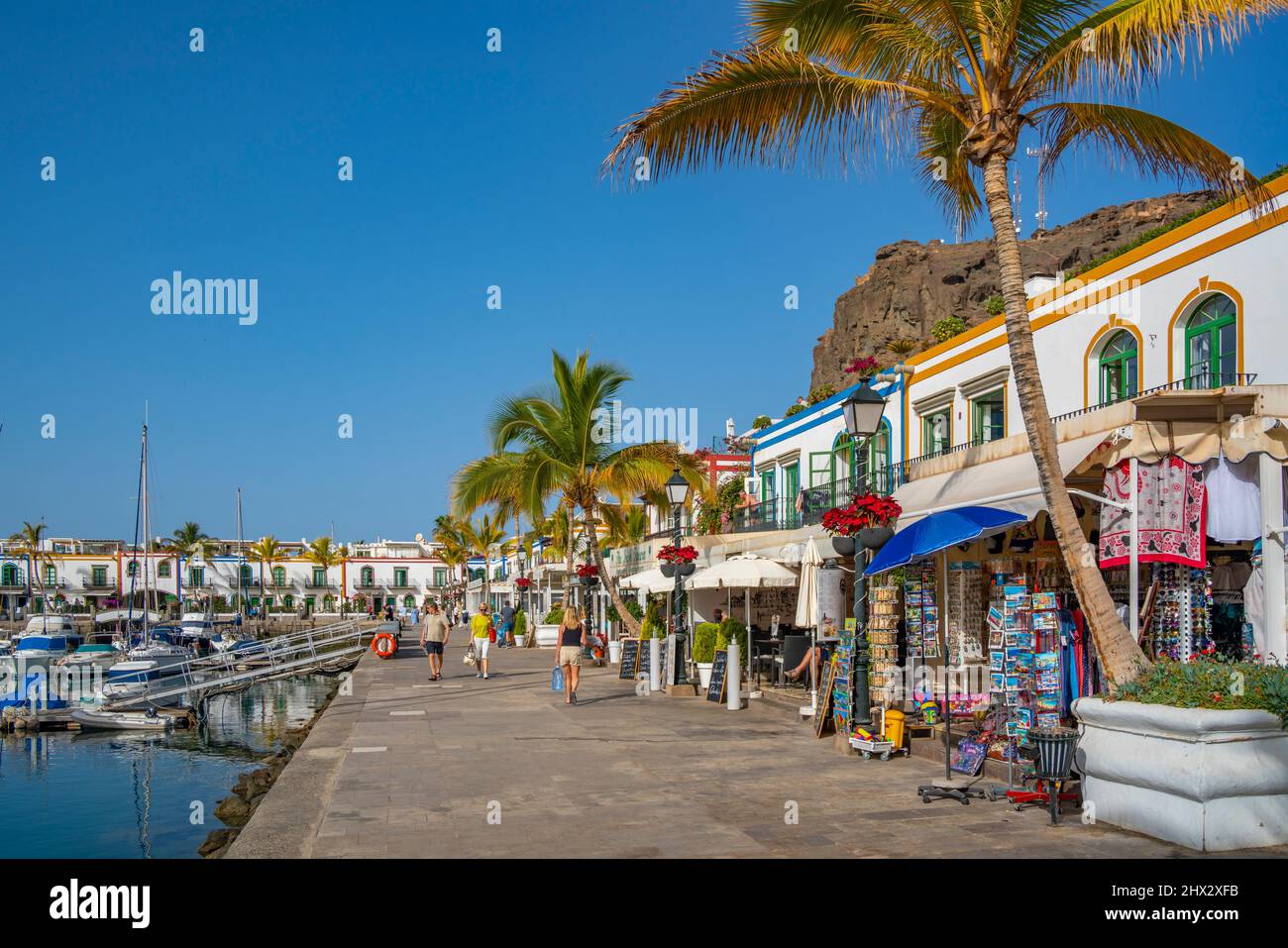 View of boats and colourful buildings along the promenade in the old town, Puerto de Mogan, Gran Canaria, Canary Islands, Spain, Europe Stock Photo