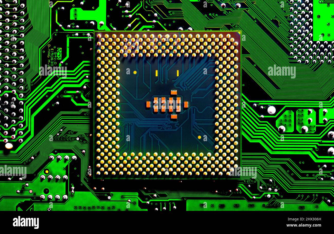 Macro Close up of microchips and pins on Main CPU PC processor circuit board. Stock Photo