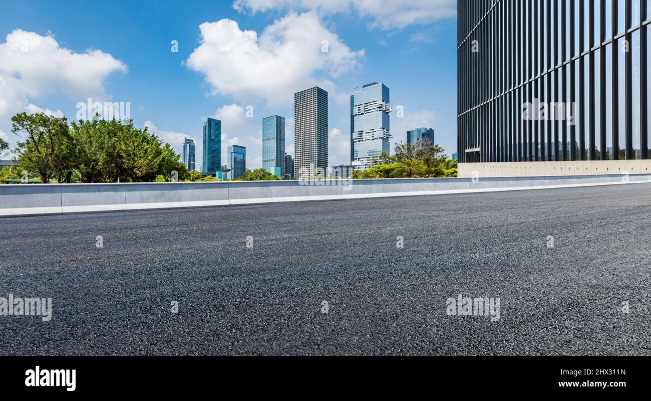 Asphalt road and city skyline with modern commercial buildings in Shenzhen, China. Stock Photo