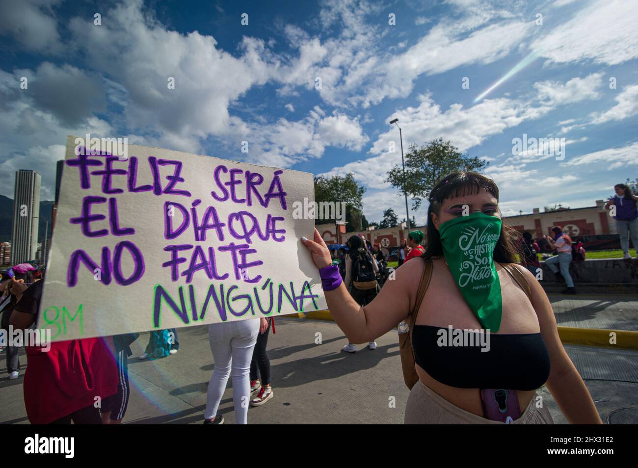 A demonstrator hold a sign that reads 'A happy day will be the day where no woman is dead' as women participate in the international womes day demonst Stock Photo