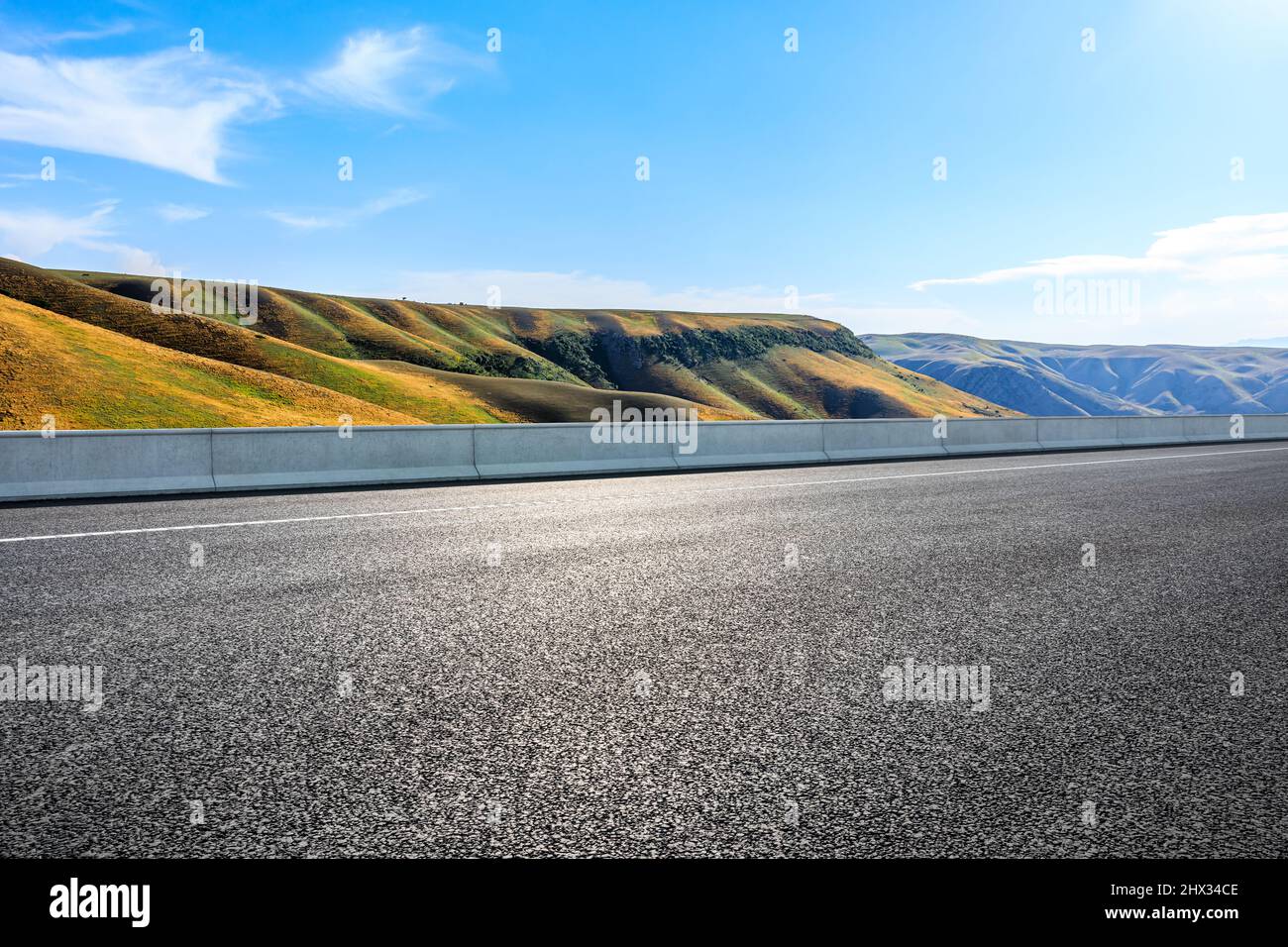 Asphalt highway and mountains with sky clouds under blue sky Stock ...
