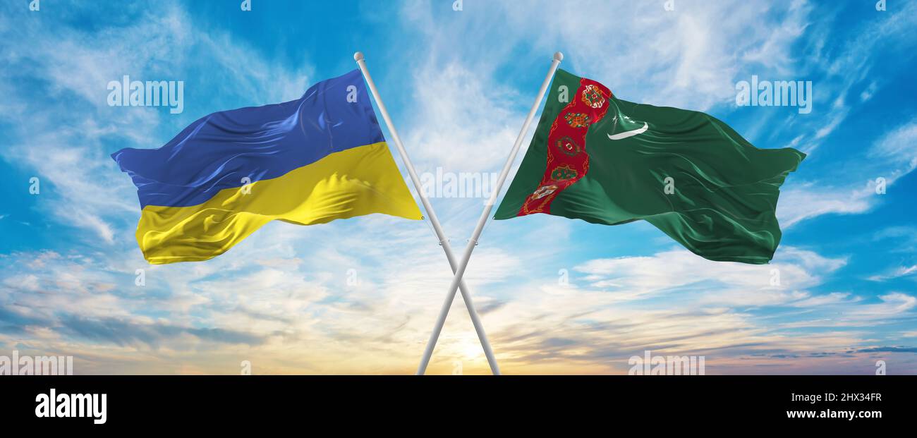 crossed national flags of Ukraine and Turkmenistan flag waving in wind ...