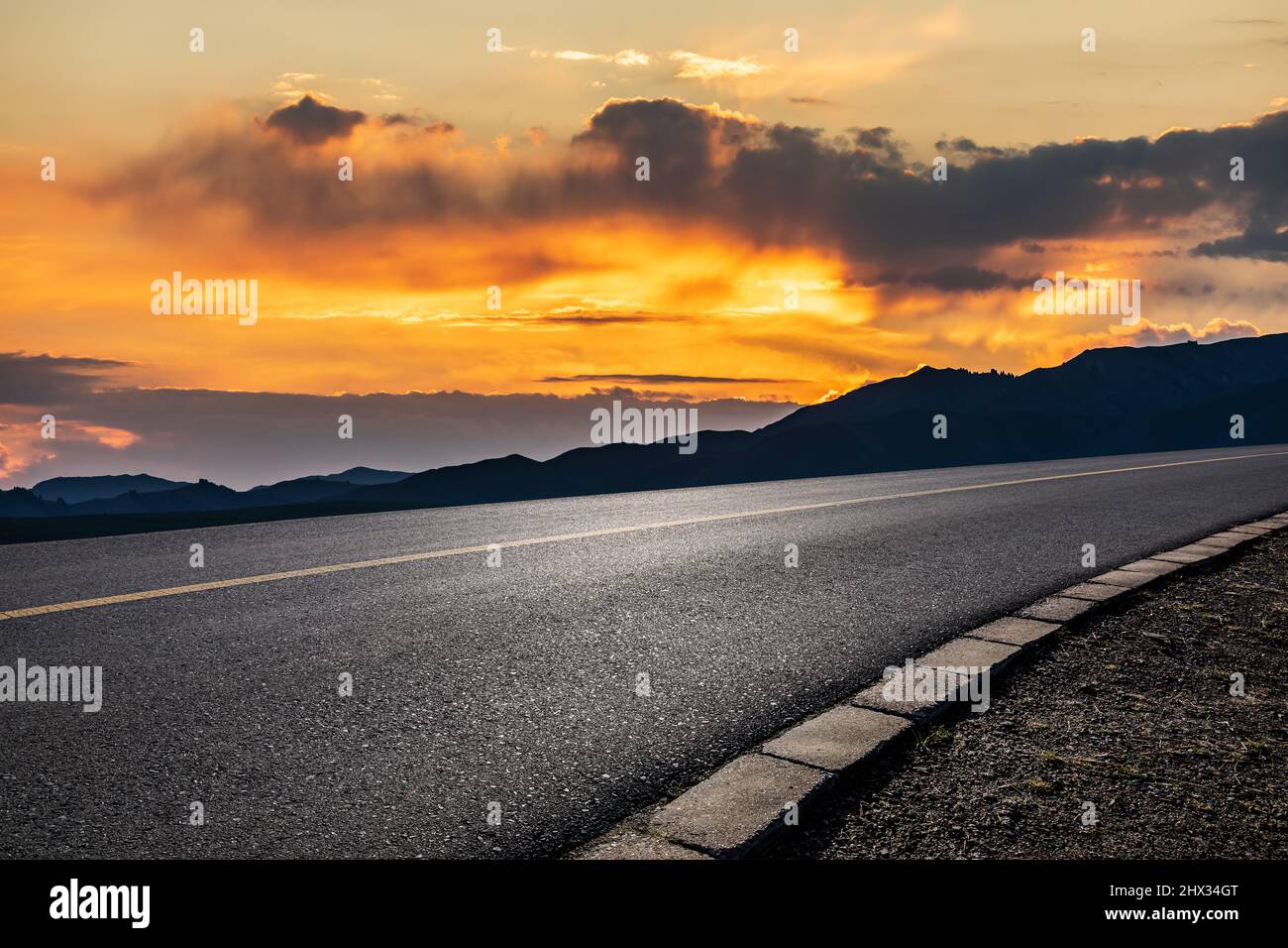 Asphalt road and mountain with beautiful sky clouds at sunset Stock ...
