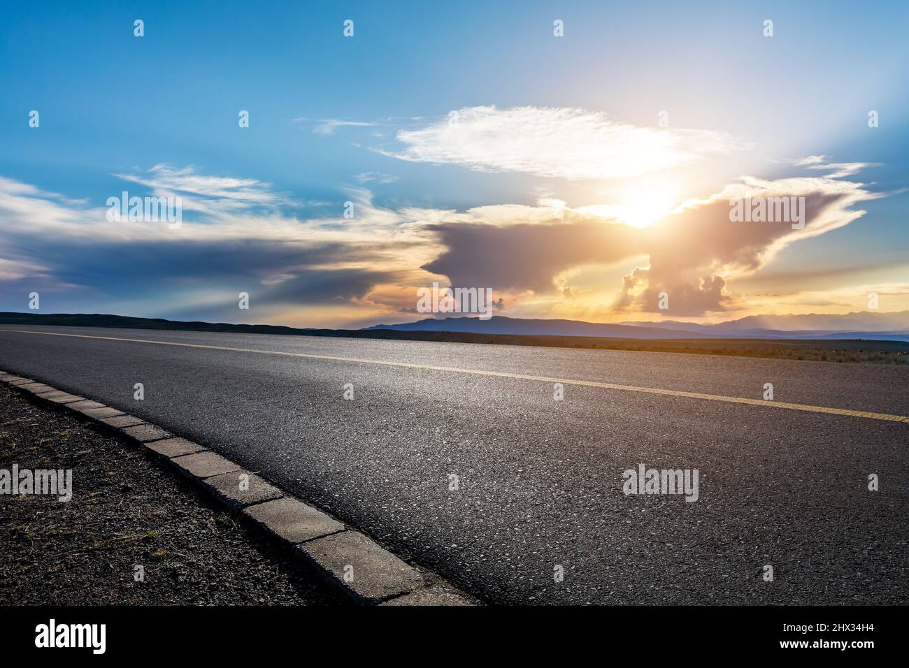 Asphalt road and mountain with beautiful sky clouds at sunset Stock ...