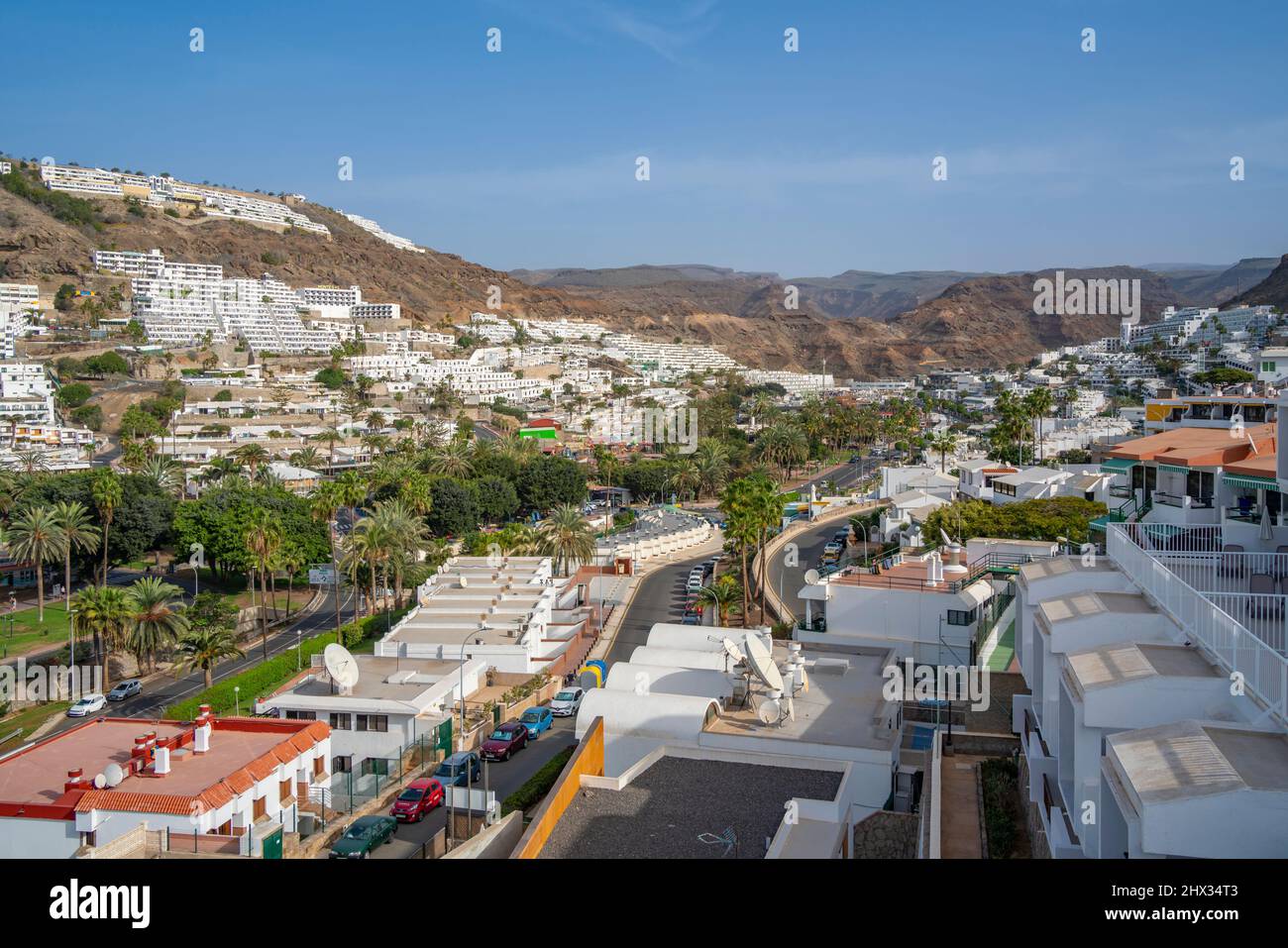 View of hotels in the town centre with mountain in background, Puerto Rico, Gran Canaria, Canary Islands, Spain, Europe Stock Photo