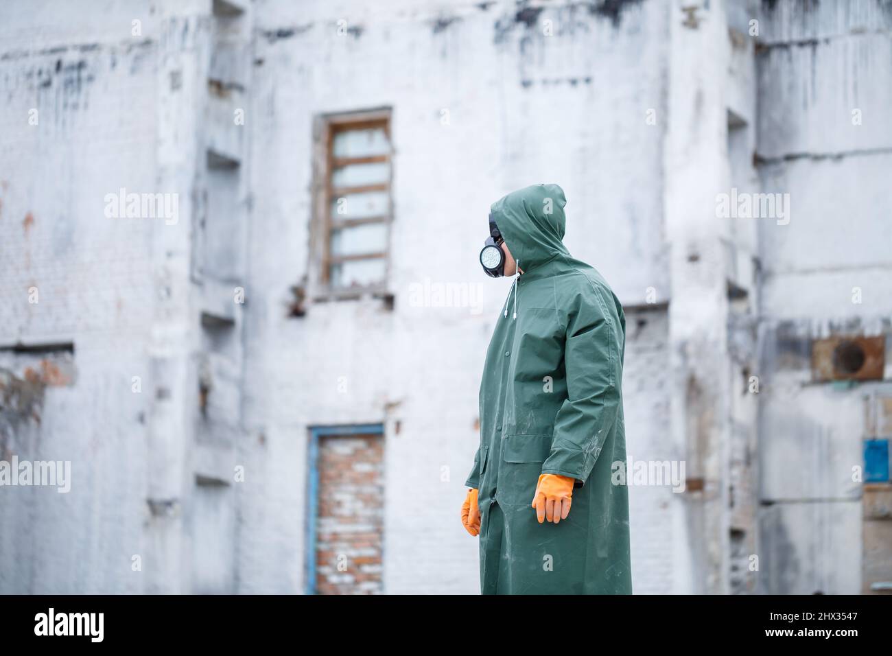 A man in a protective mask and protective clothing explores a dangerous