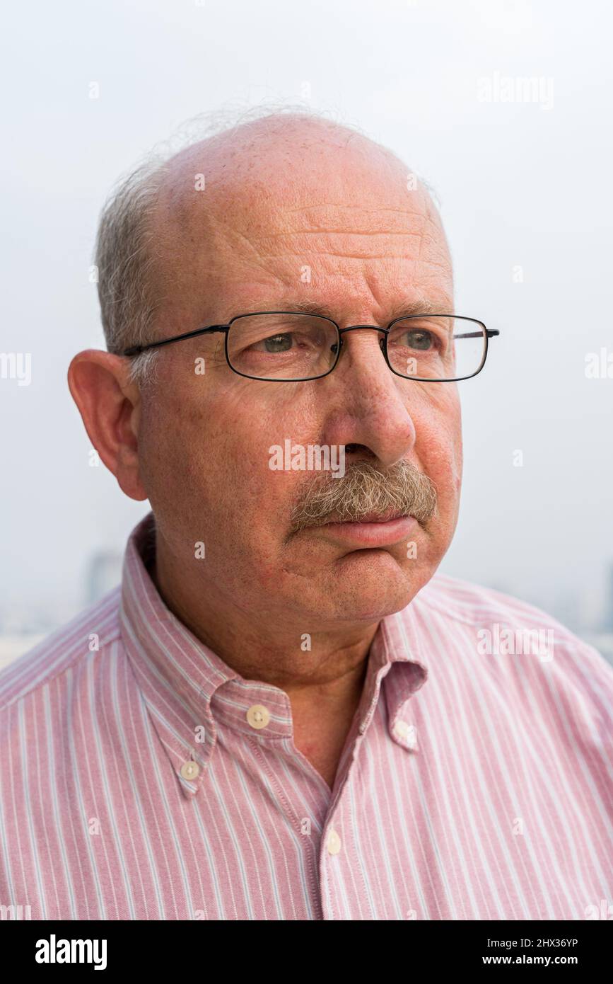 Portrait of senior businessman looking at camera in city at rooftop Stock Photo