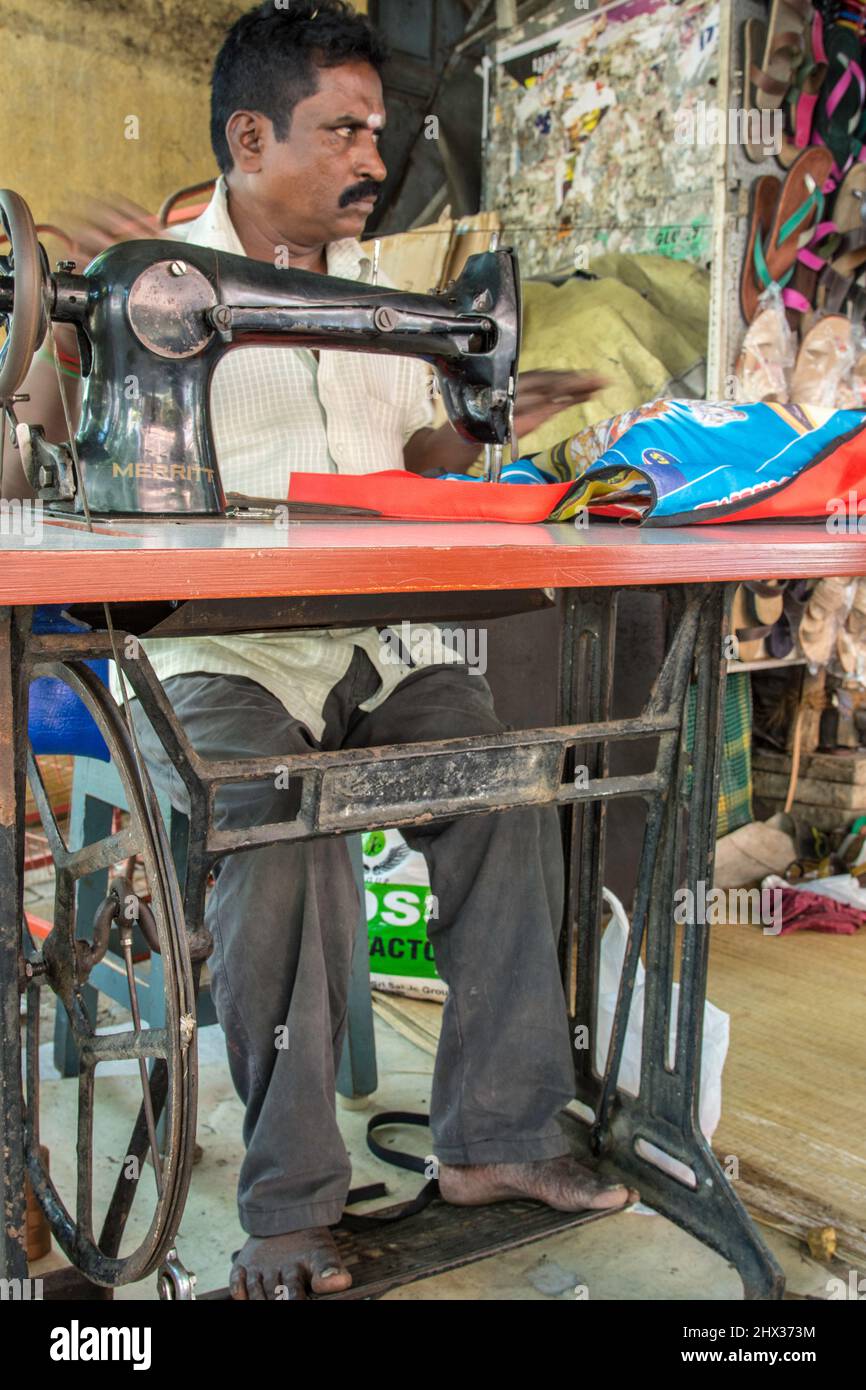 tailor with sewing machine in a Market Stall, India Stock Photo