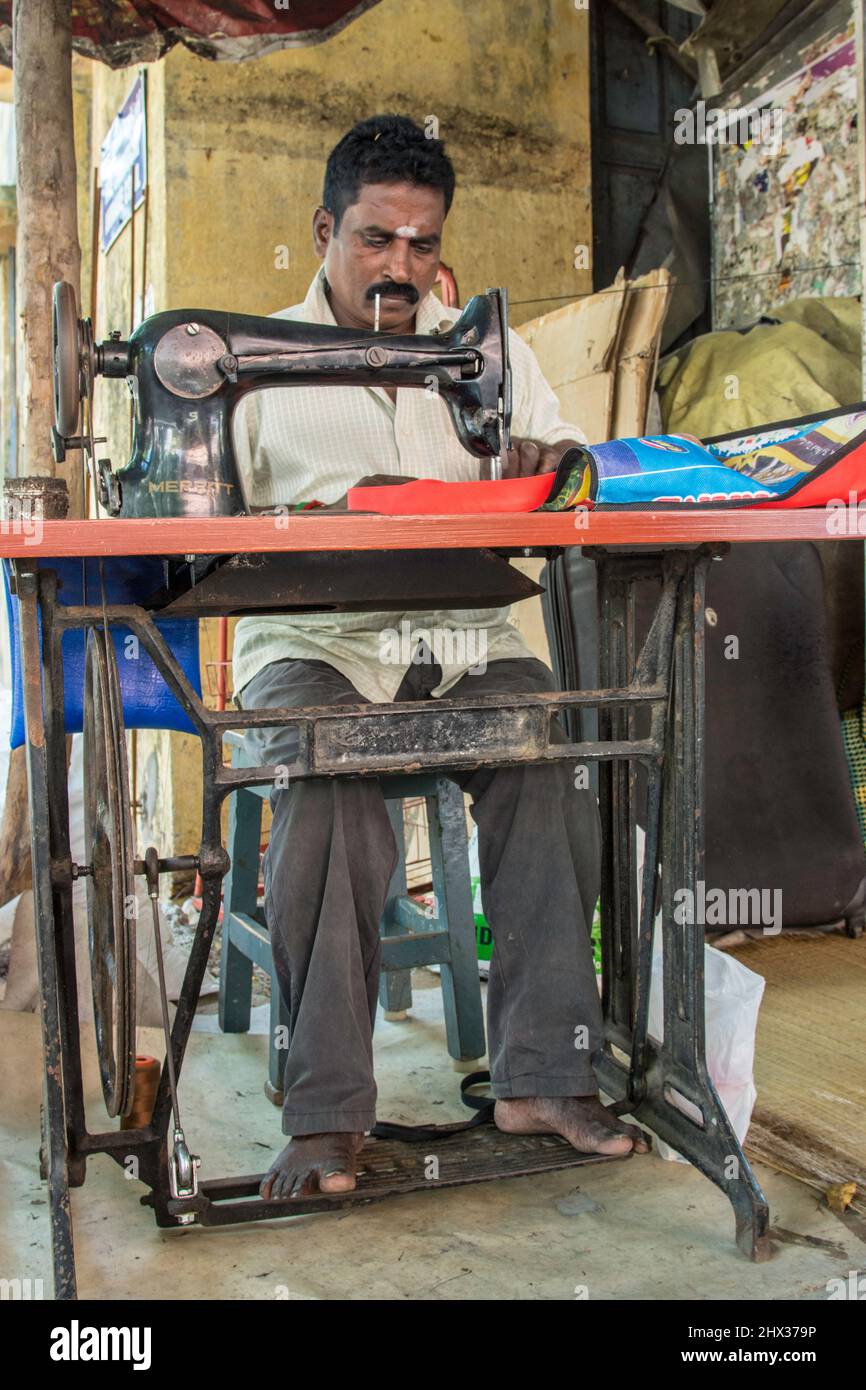 tailor with sewing machine in a Market Stall, India Stock Photo