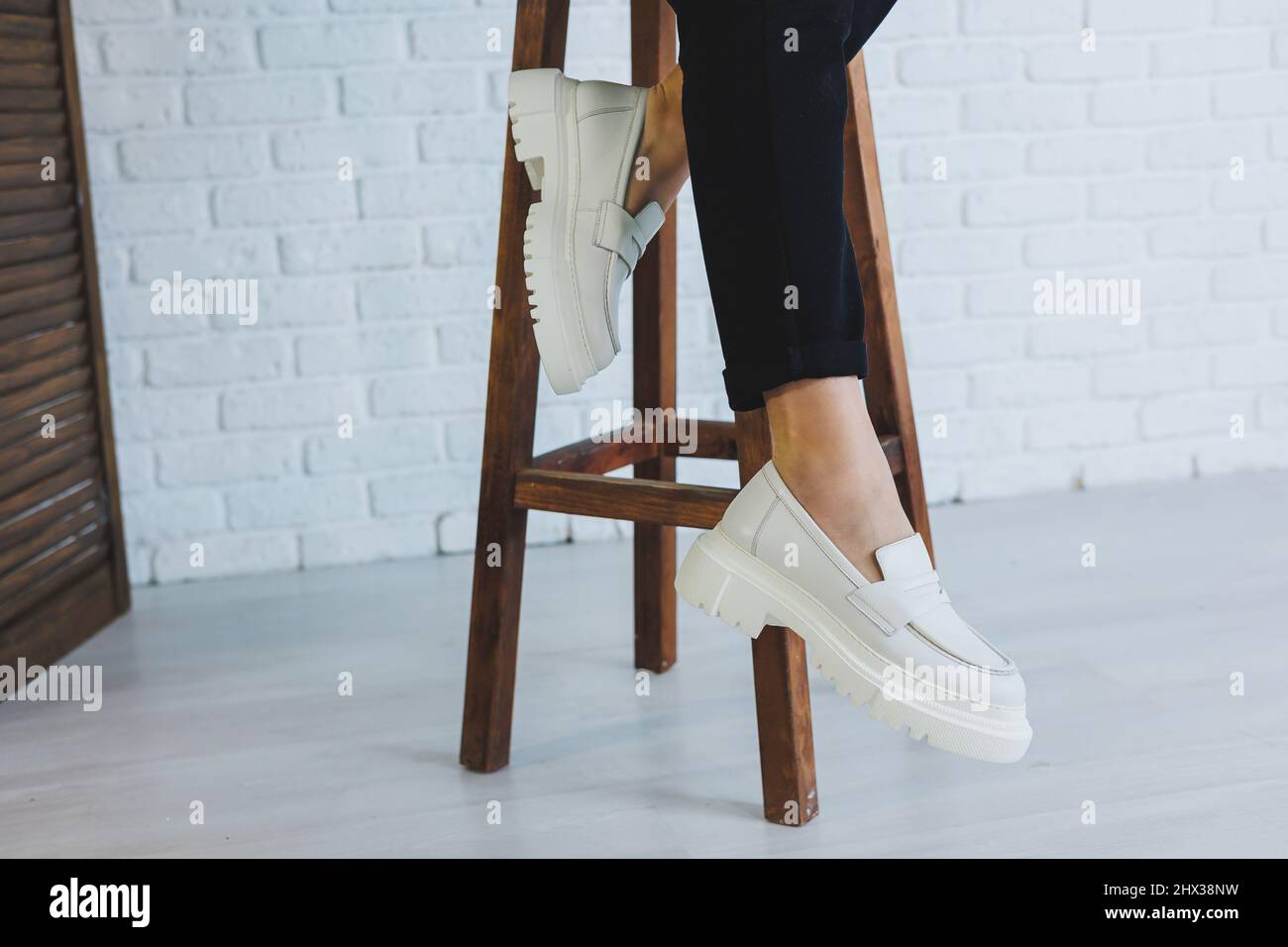 Legs of a young beautiful woman in black trousers and modern stylish