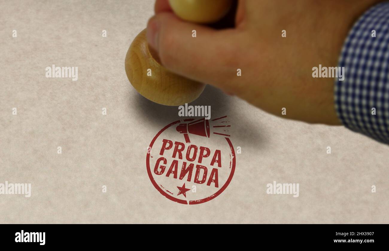 Propaganda stamp and stamping hand. Manipulation, fake news and disinformation concept. Stock Photo