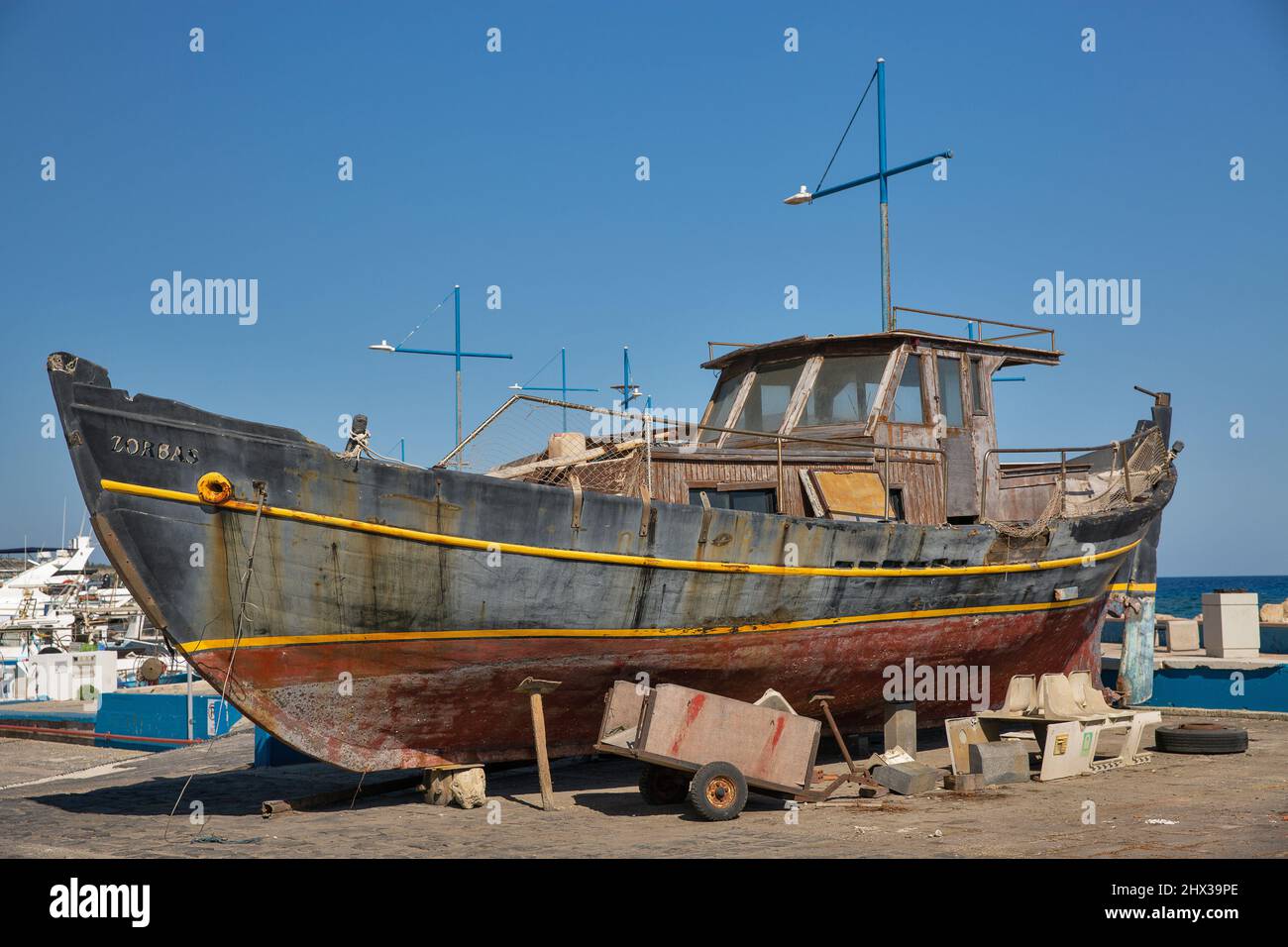 Ayia Napa, Cyprus - May 23, 2021: Old famous fishing boat Zorbas in seaport. Ayia Napa is a tourist resort at the far eastern end of the southern coas Stock Photo
