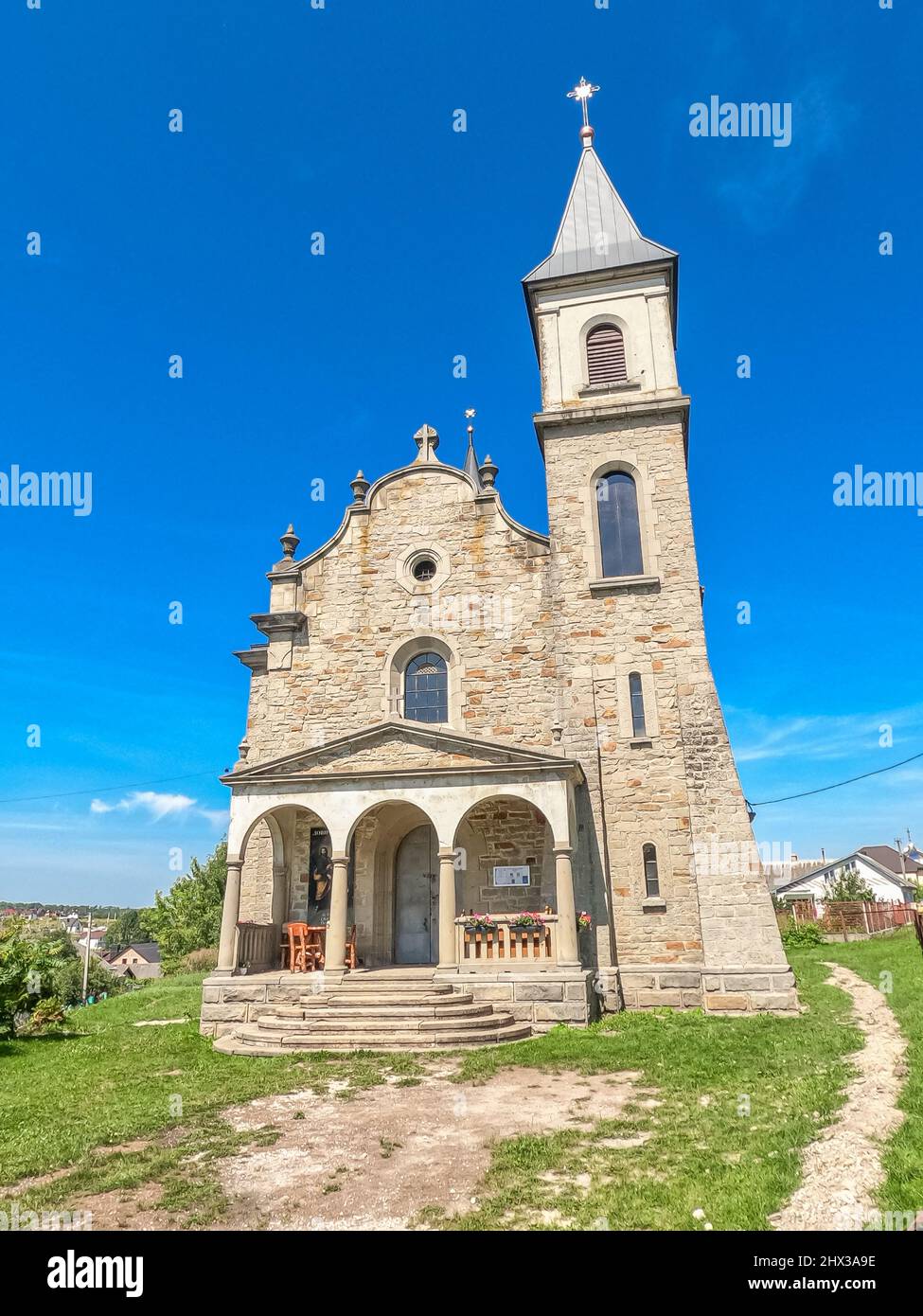 Small ancient church on background of blue sky in countryside. Stone ...
