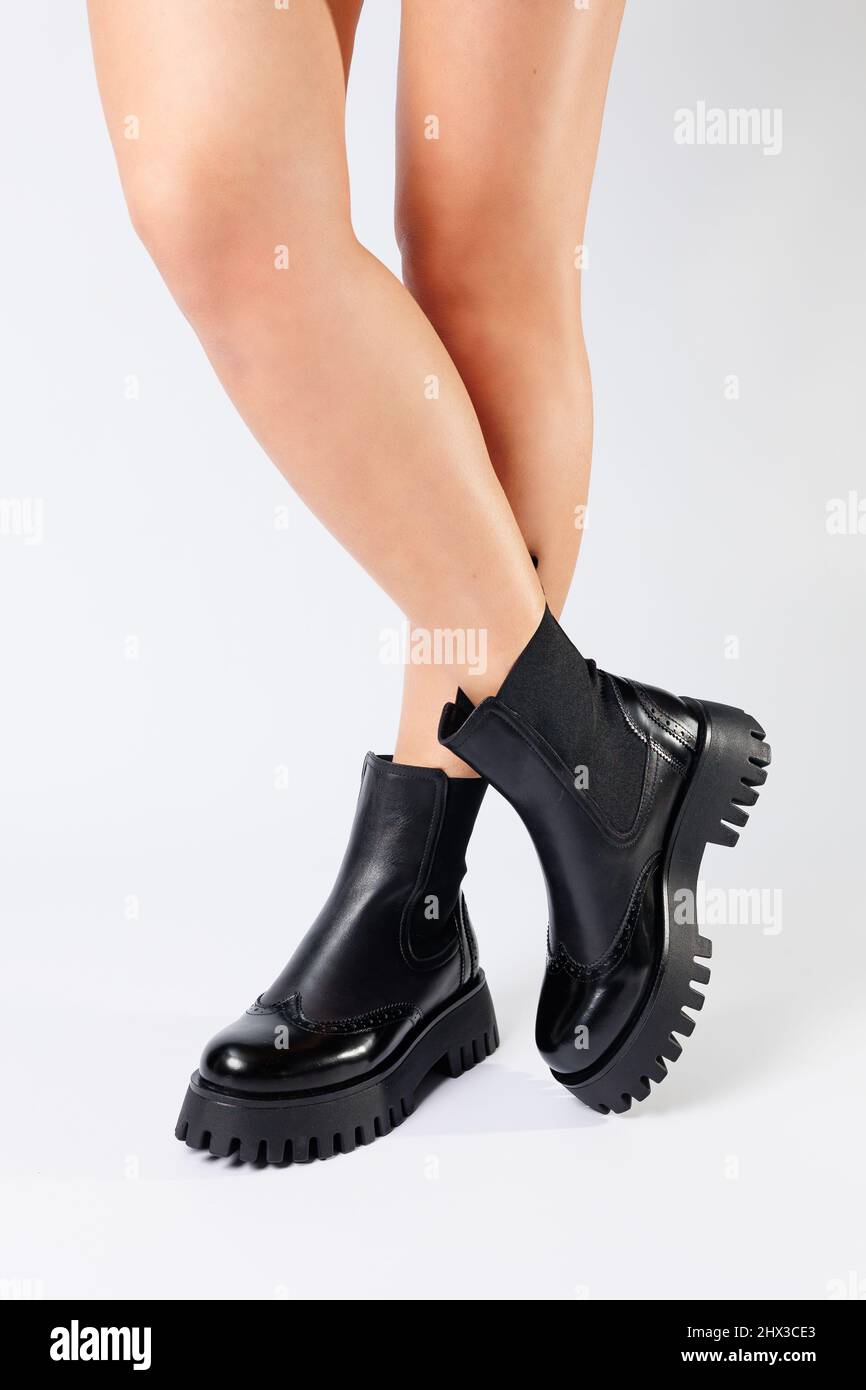 New collection of women's shoes spring 2022. girl's legs in new shoes. Legs  in black boots. Low running boots made of genuine leather Stock Photo -  Alamy