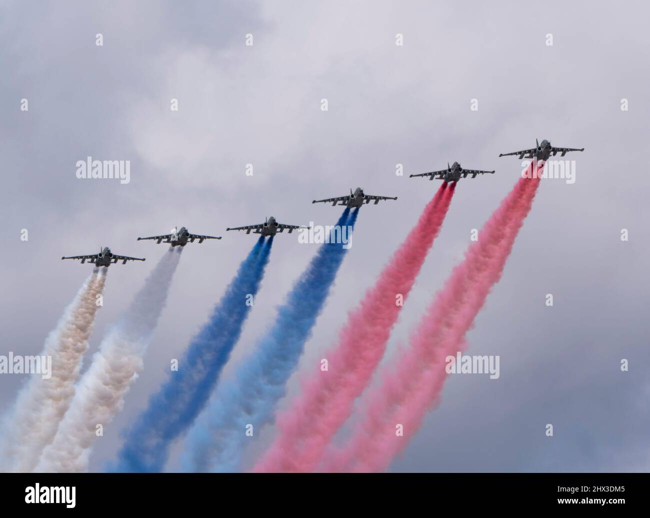 MOSCOW, RUSSIA - MAY 7, 2021: Avia parade in Moscow. Group of Russian fighters Sukhoi Su-25 with painted russian flag in the sky on parade of Victory Stock Photo