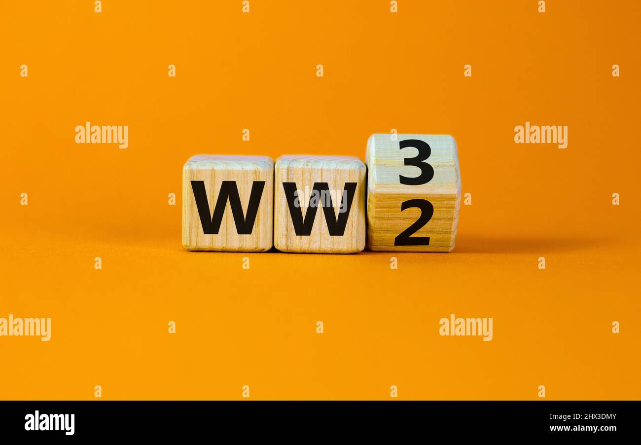WW3 world war 3 symbol. Turned the wooden cube and changed the concept word WW2 to WW3. Beautiful orange table orange background, copy space. Business Stock Photo