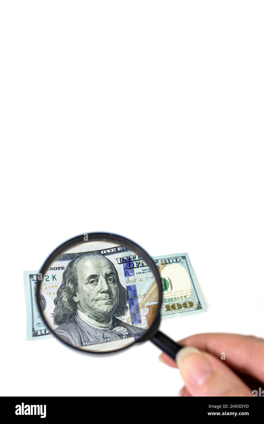 Magnifying glass on dollar banknotes. Hundred dollars banknote ...