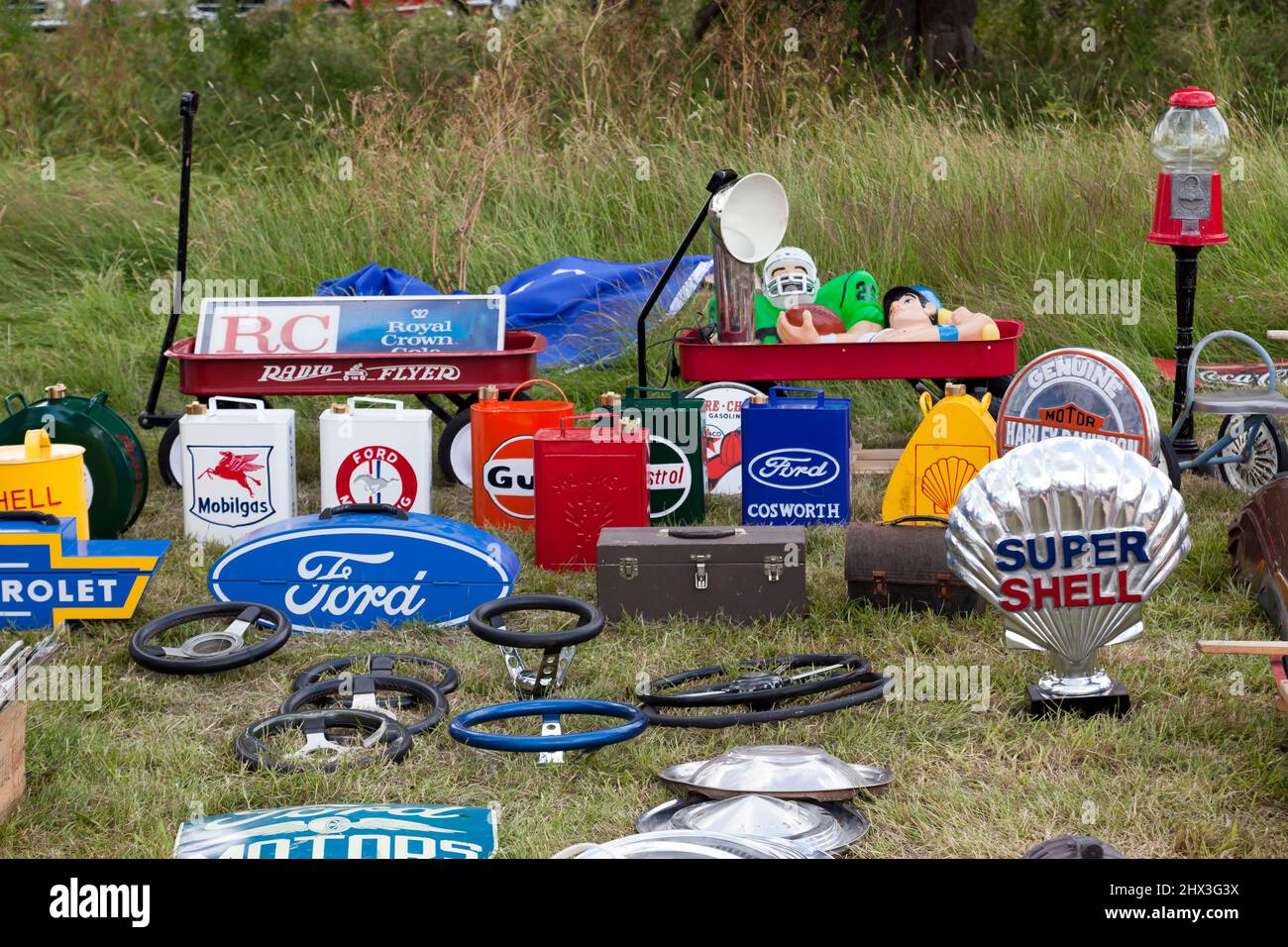 Closeup of some Vintage Petrol Pump Signs, Petrol Cans, and Steering