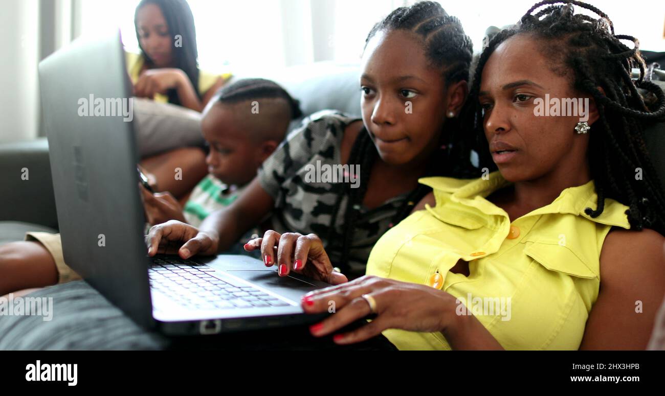 Happy black African american family using laptop Stock Photo - Alamy